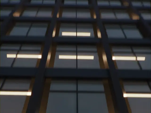 La façade vitrée d'un immeuble de bureaux, de nuit